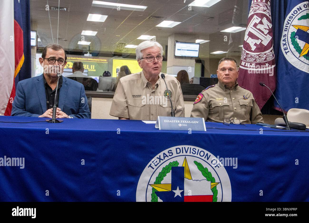 Austin Texas USA, July 4 2025: An emotional Texas Lt. Governor DAN PATRICK (c) briefs the media about ongoing rescue efforts in Kerr County near San Antonio where at least 13 people have been killed in flash flooding along the Guadalupe River. At left is state Sen. PETE FLORES, whose district includes Kerr County; at right is Texas Department of Public Safety director FREEMAN F. MARTIN. Credit: Bob Daemmrich/Alamy Live News Stock Photo