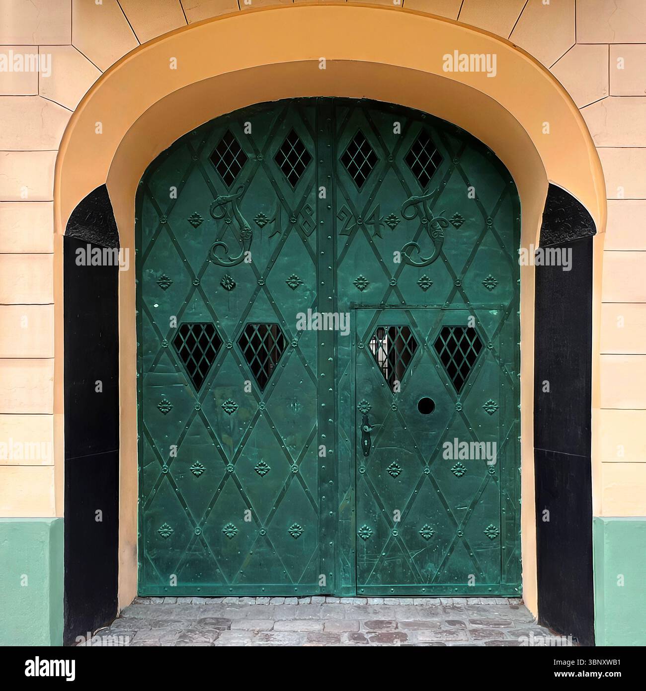 A dark green iron gate in Warsaw, Poland, dated 1824, features diamond motifs and heart-shaped grilles, set in a warmly arched, historic facade. - Smartphone Captured Stock Image
