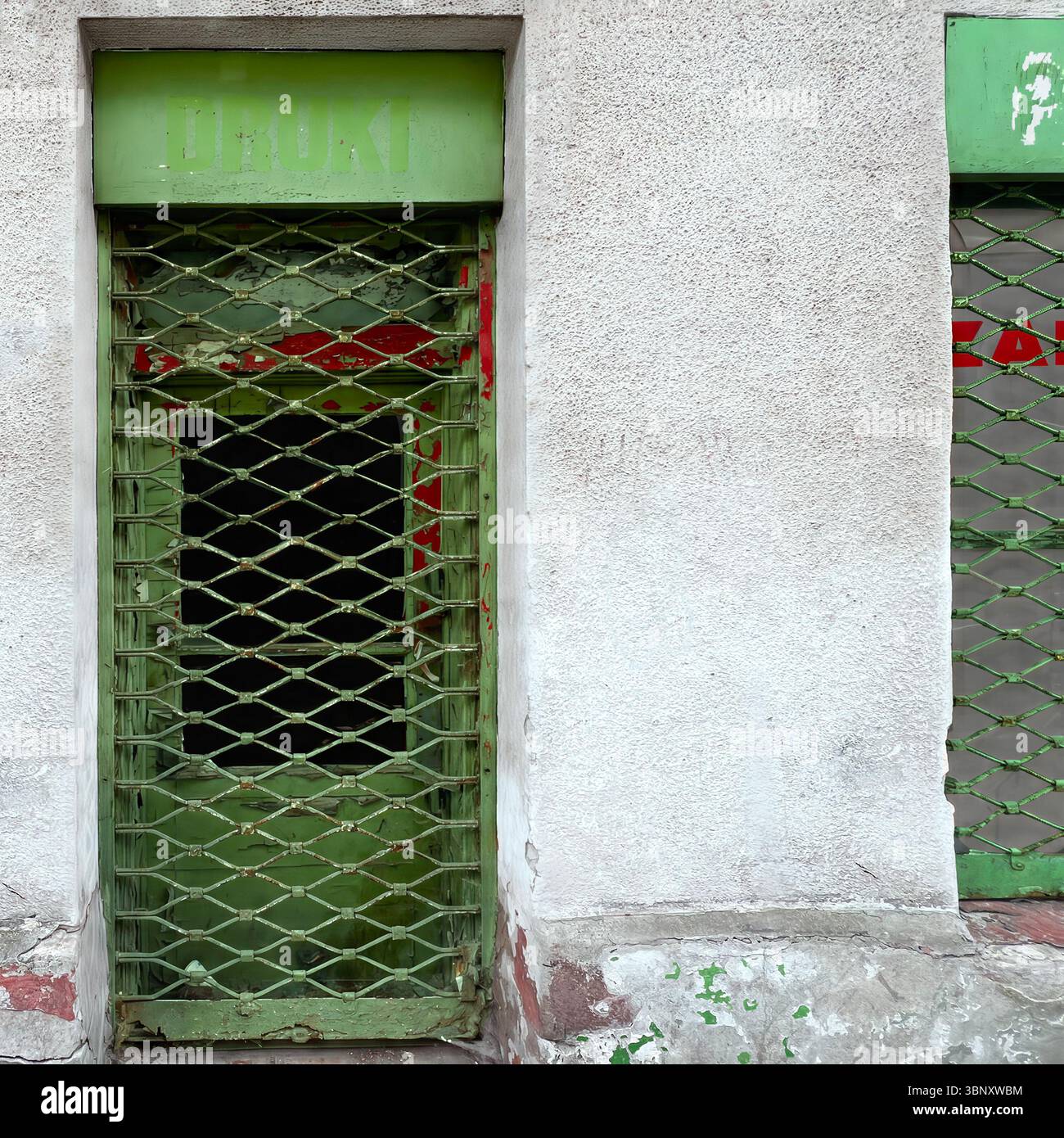A faded green storefront  in Warsaw, Poland, sits shuttered behind a rusty grille—an echo of postwar commerce and forgotten print shops. - Smartphone Captured Stock Image