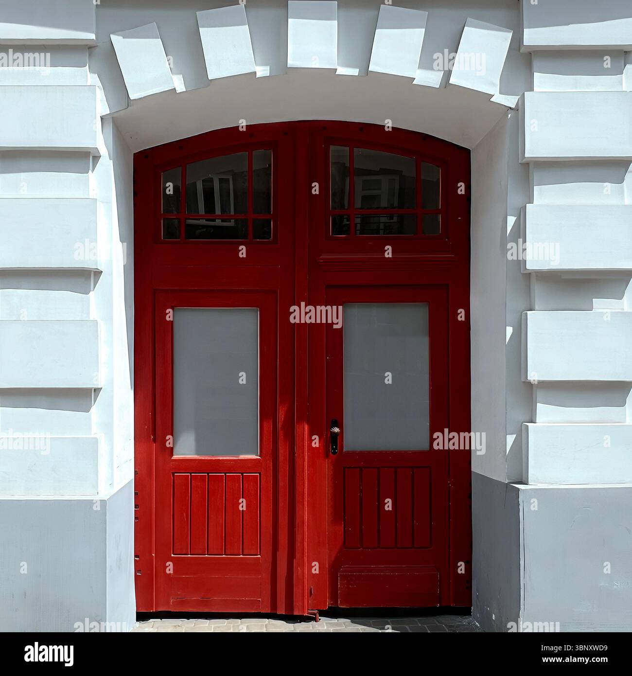 Arched red double doors with frosted glass panels stand out boldly against a pristine white neoclassical facade in Warsaw. - Smartphone Captured Stock Image