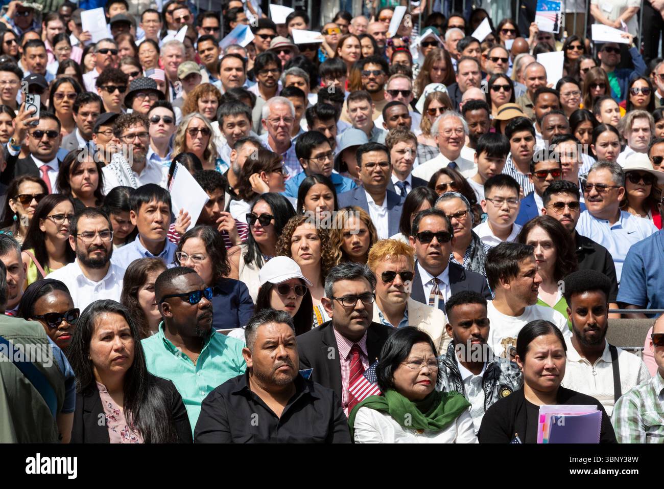 Seattle, Washington, USA. 4th July 2025. Immigrants gather for a naturalization ceremony at Fisher Pavilion. The Honorable David G. Estudillo, Chief United States District Judge for the Western District Court of Washington, swore in 501 applicants from 79 countries as new citizens at Seattle Center’s 40th Annual Naturalization Ceremony. Credit: Paul Christian Gordon/Alamy Live News Stock Photo