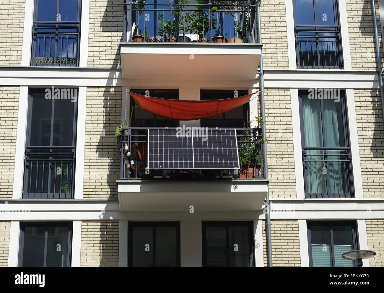 04 July 2025, Berlin: A so-called balcony power plant is attached to a ...