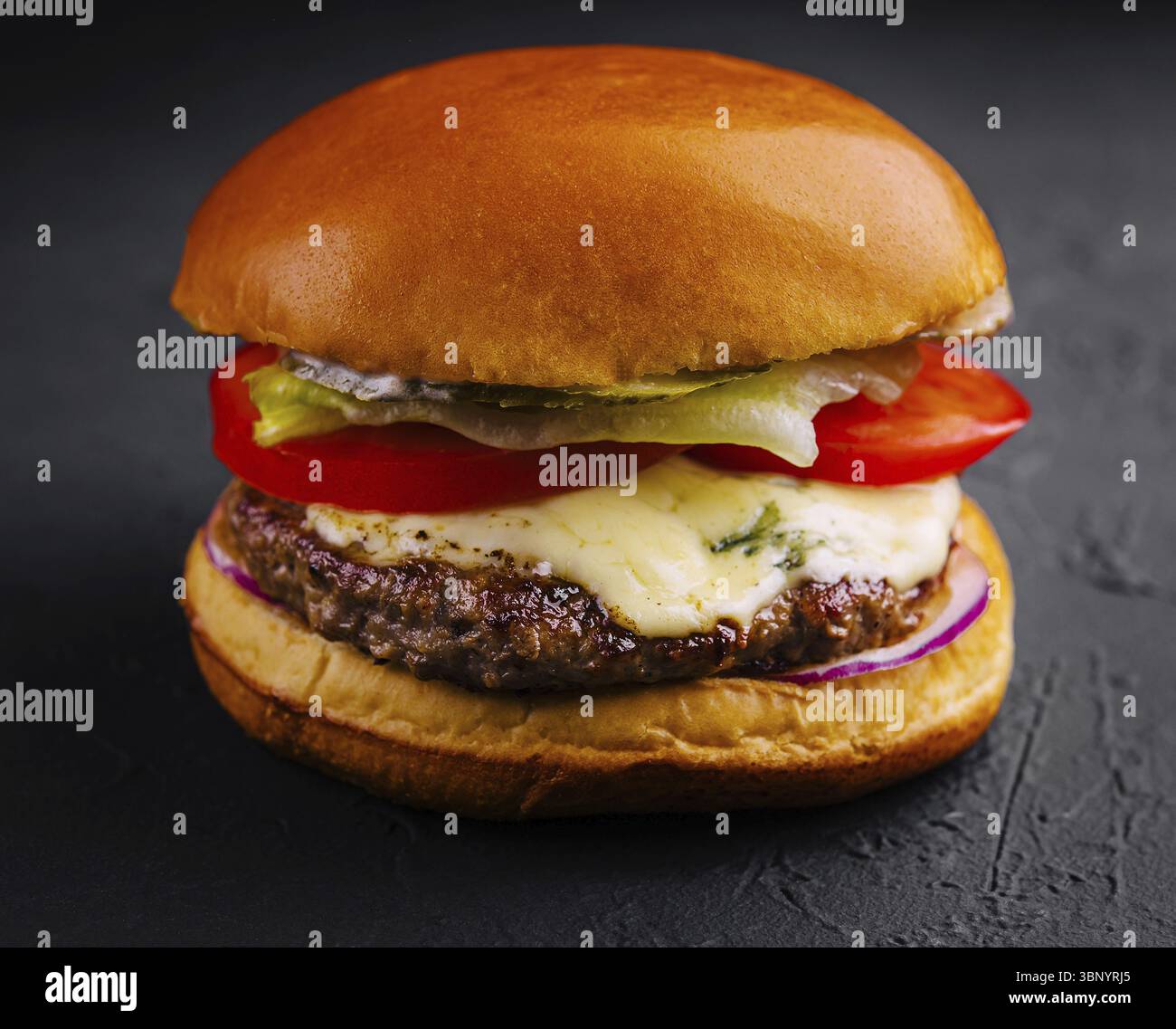 food still-life, Delicious cheeseburger on a black background Stock Photo