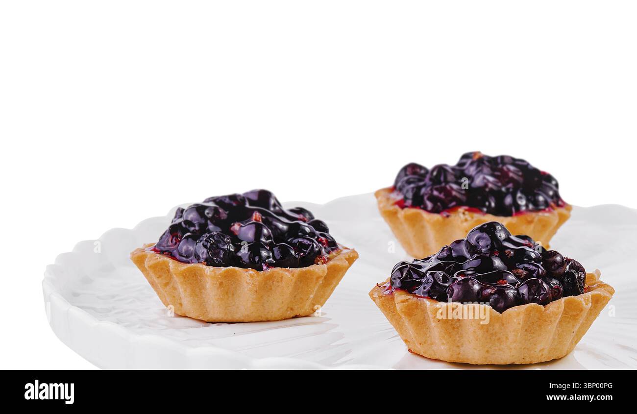 Small cakes with currant on white big plate Stock Photo