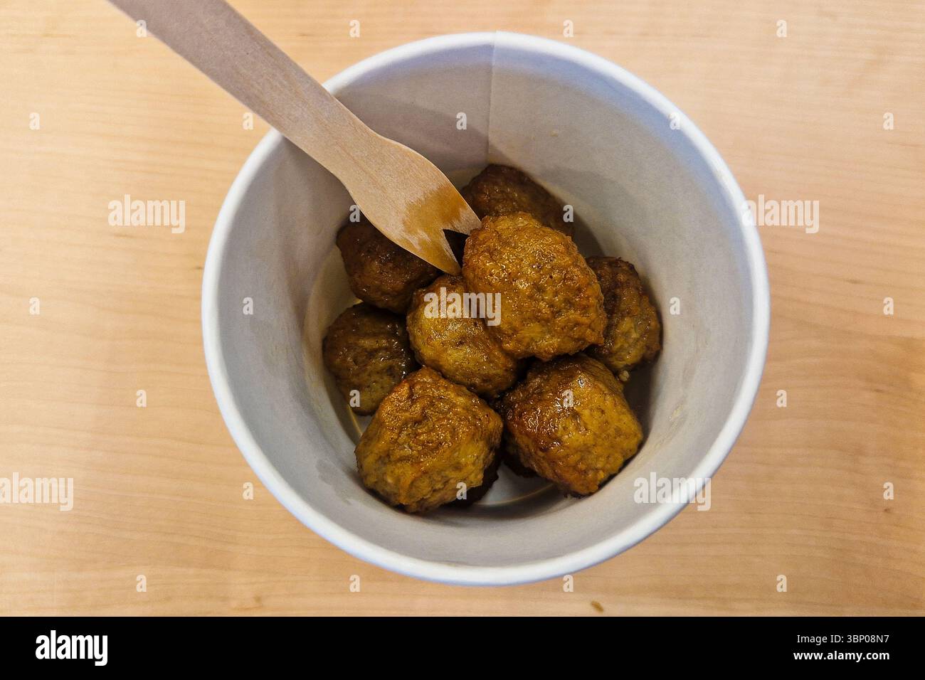 Tallinn, Estonia - June 19, 2025: Popular Swedish meatballs in paper cup with wooden fork at IKEA food court or café area. Casual Scandinavian retail - Smartphone Captured Stock Image