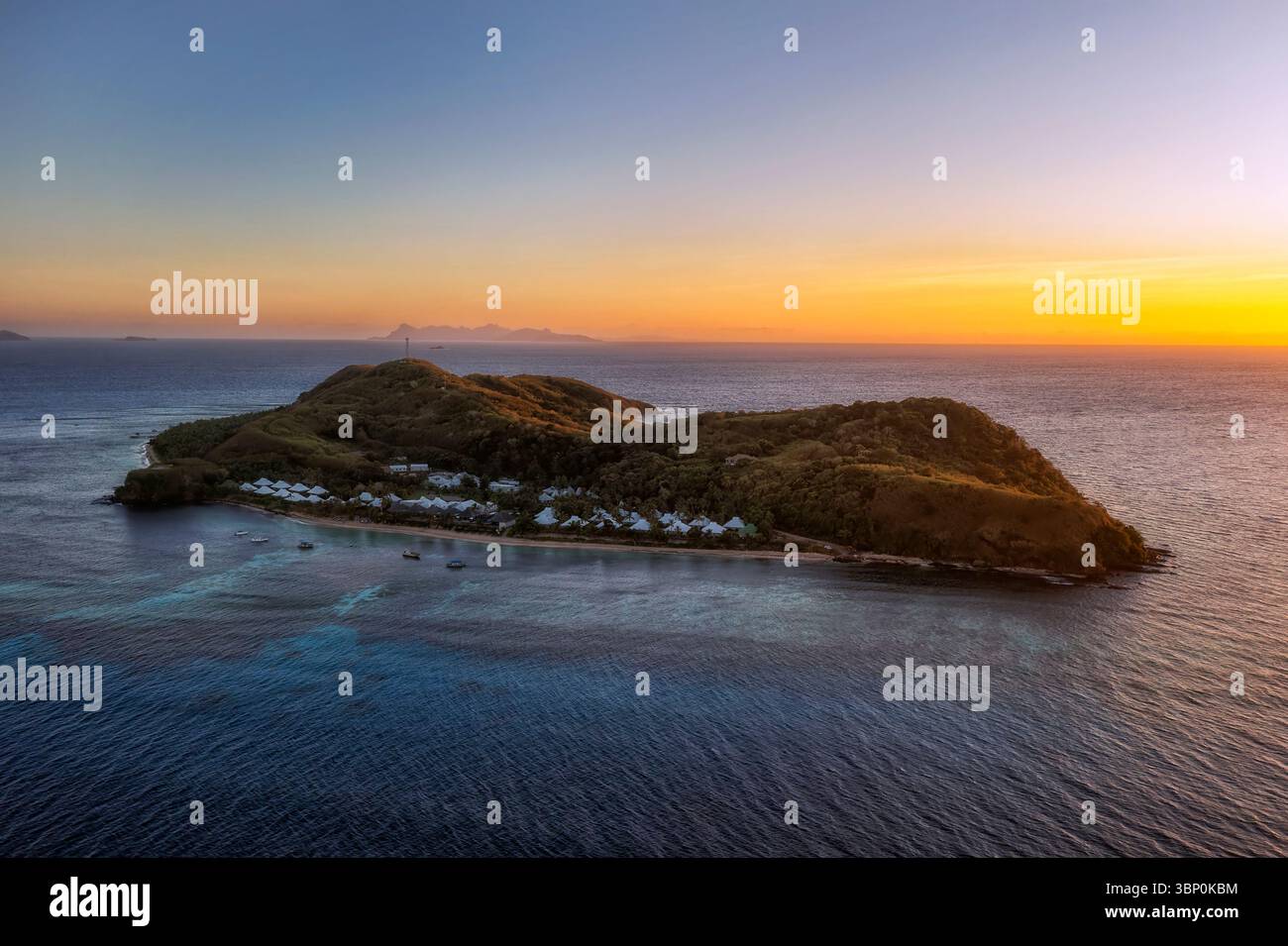 Remote tourism resort Tokoriki island in Fiji at sunrise - scenic aerial seascape. Stock Photo
