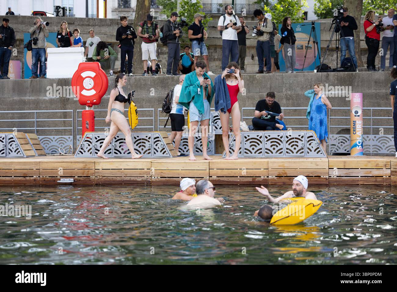 Paris, France. 05th July, 2025. People swim at the Pont Marie safe ...