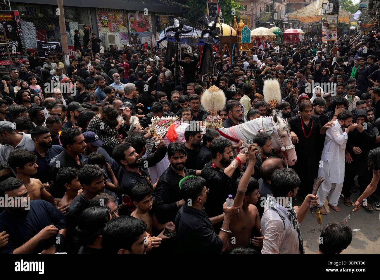 Shiite Muslims participate in a Muharram procession in Lahore, Pakistan ...