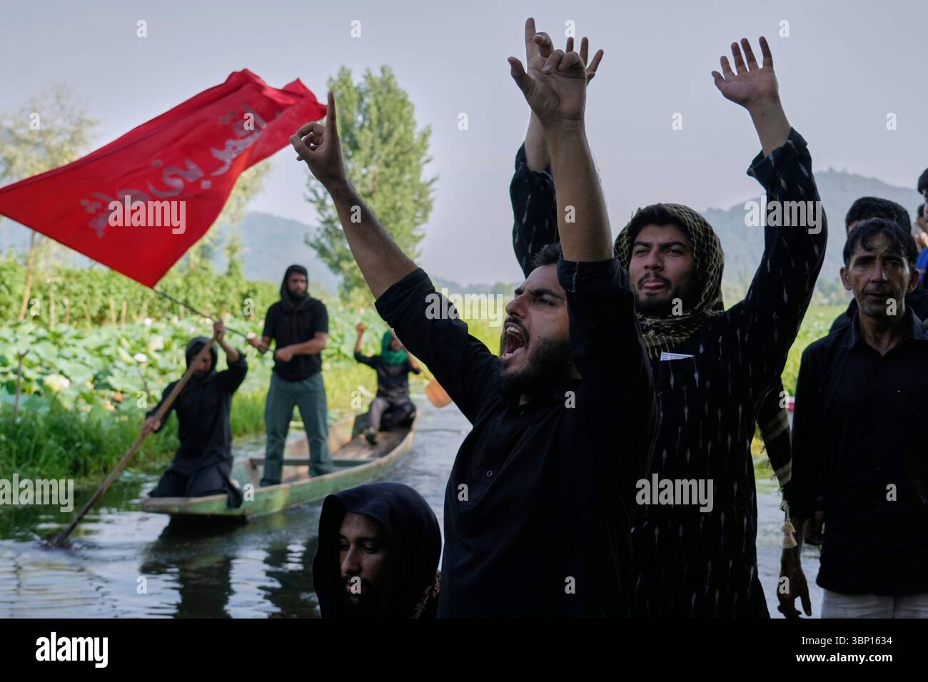 Kashmiri Shiite Muslims shout religious slogans as they participate in ...
