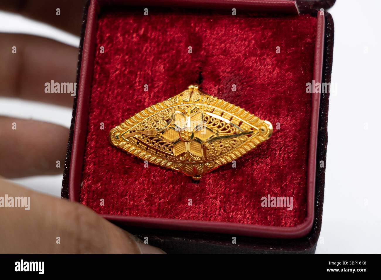 gold wedding ring with a box on a light background. Stock Photo