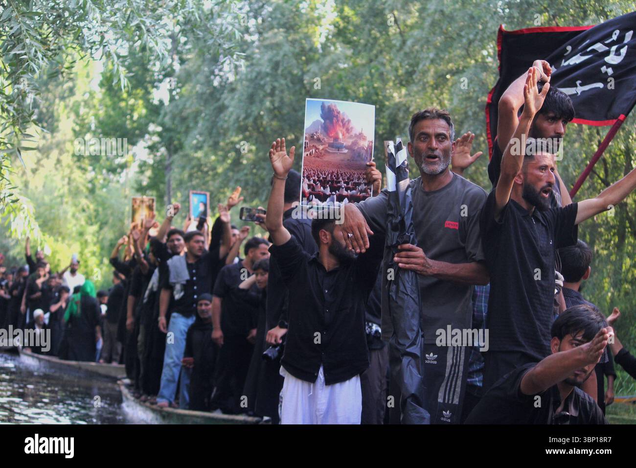 Kashmiri Shiite Muslims shout religious slogans and hold placards ...