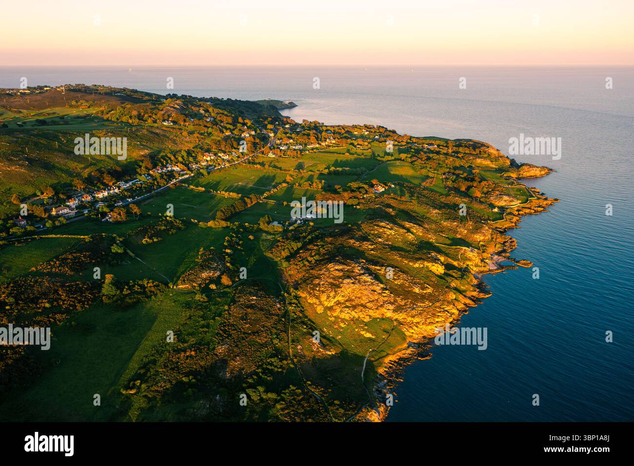 Aerial Coastal View of Sutton South and Howth’s Rugged Shoreline at Sunset Stock Photo
