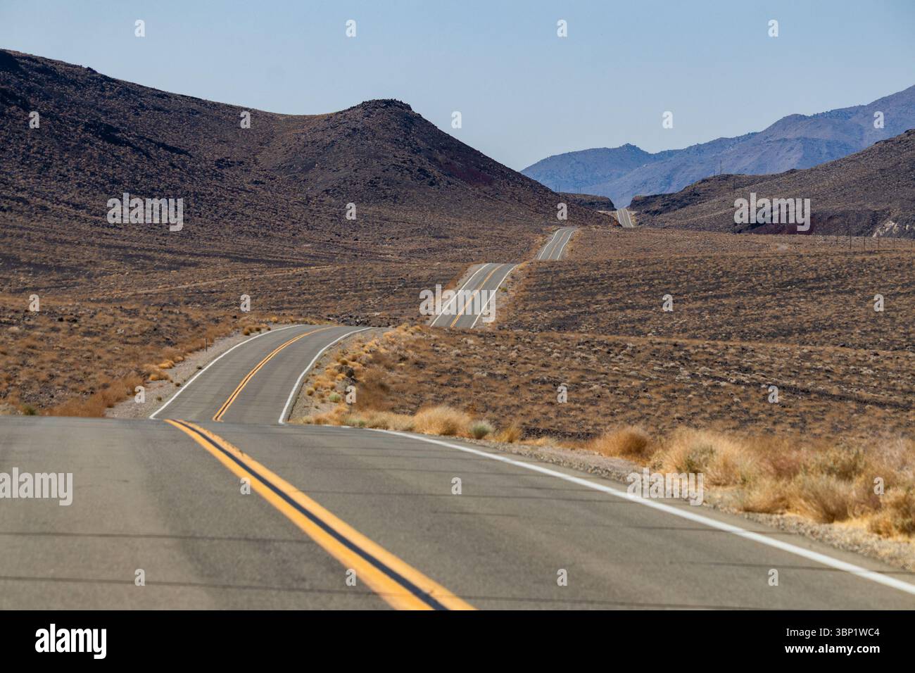 The up and down road heading into the western side of Death Valley National park. Stock Photo