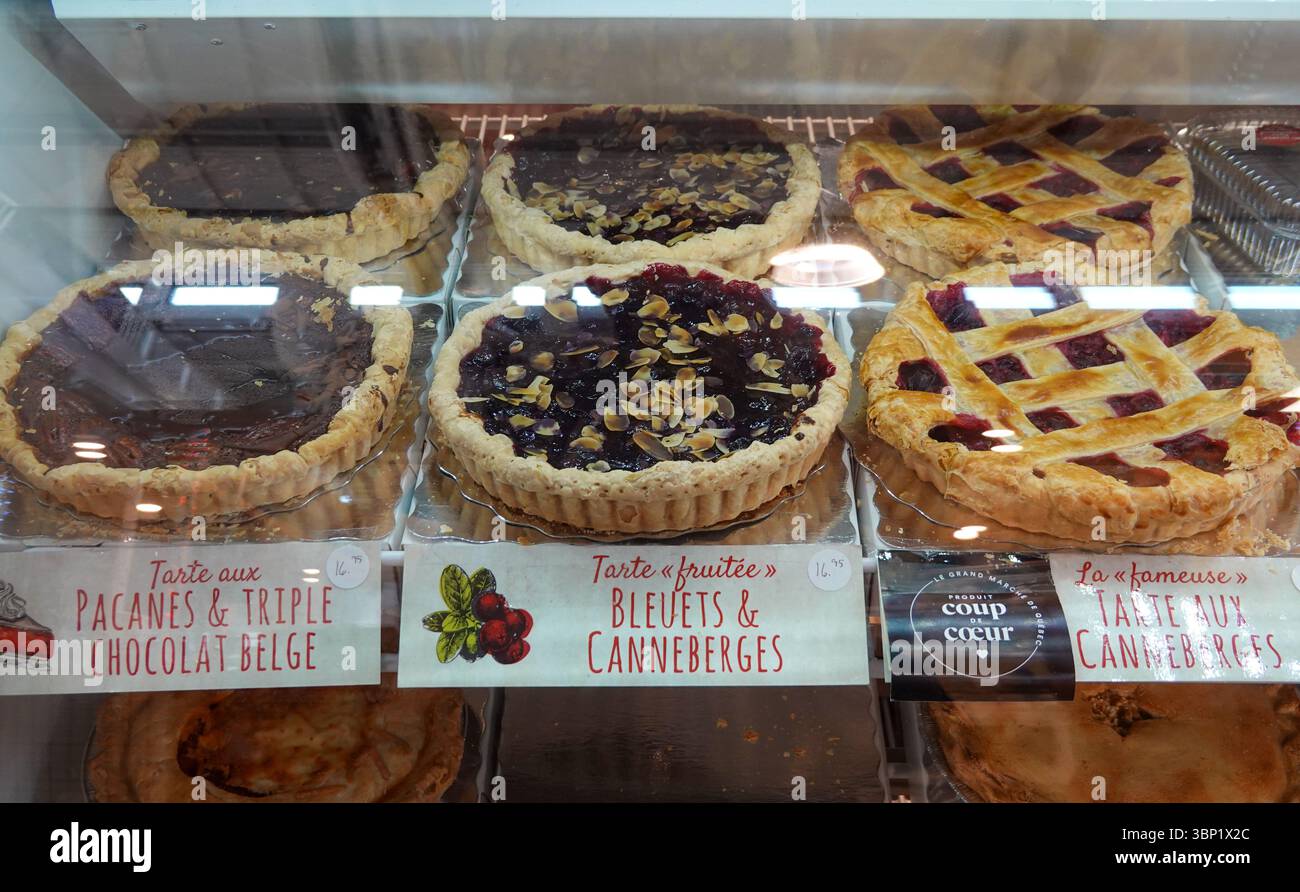 Delicious assortment of fresh pies and tarts displayed in bakery case Stock Photo