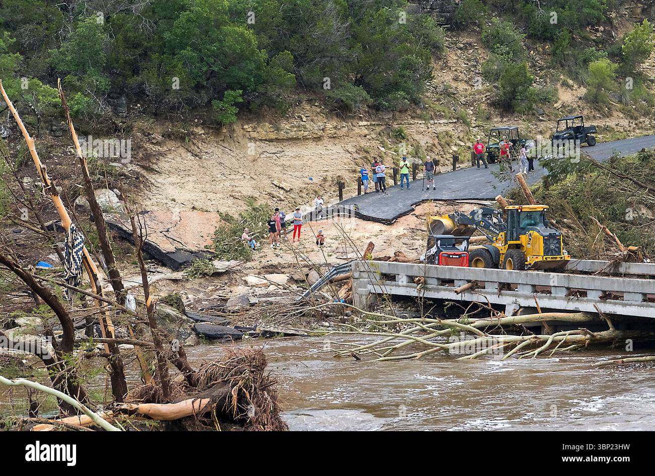 Crews work to clear debris from the Cade Loop bridge along the ...