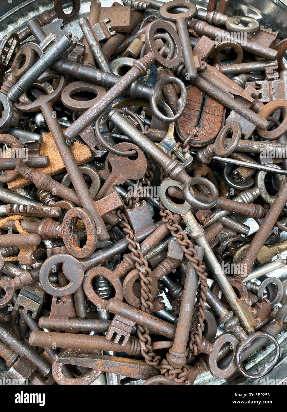 Many old copper iron keys covered with patina, old dutch vintage keys, top view - Smartphone Captured Stock Image