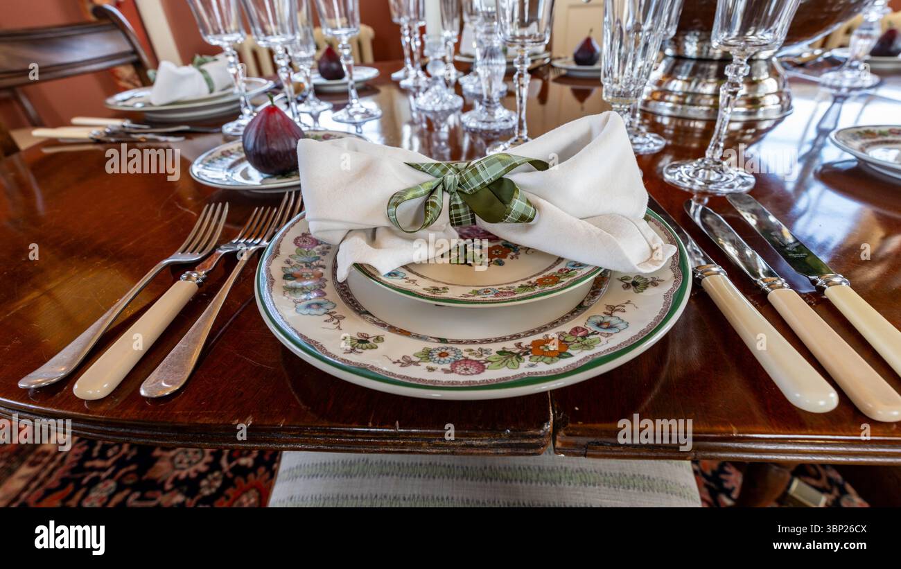 Elegant place setting with antique floral china, silverware, crystal ...