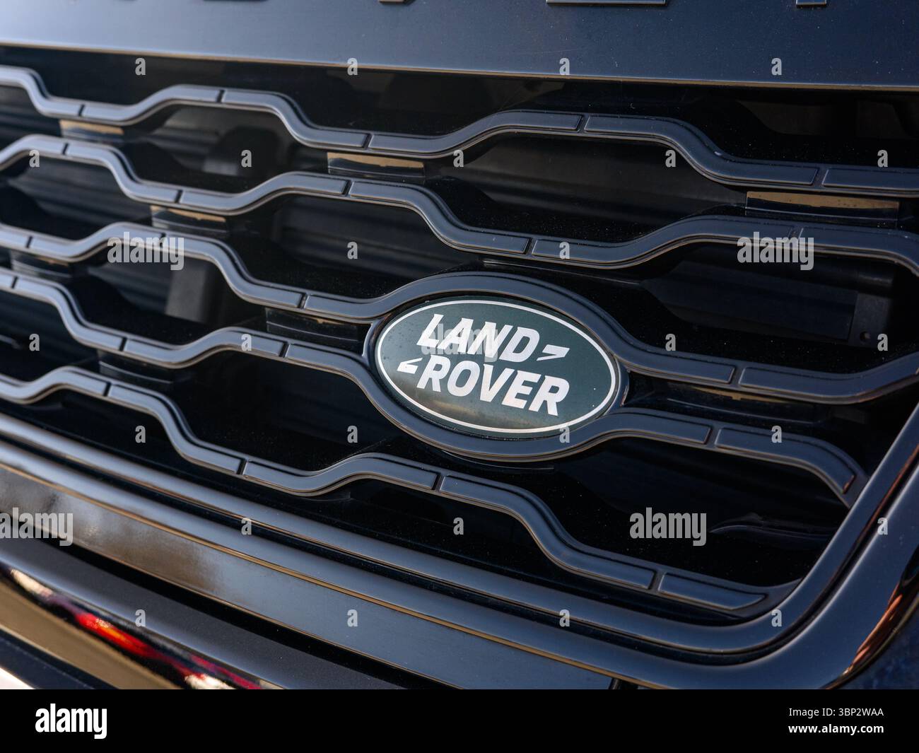 This image captures a detailed close-up of the iconic green Land Rover ...