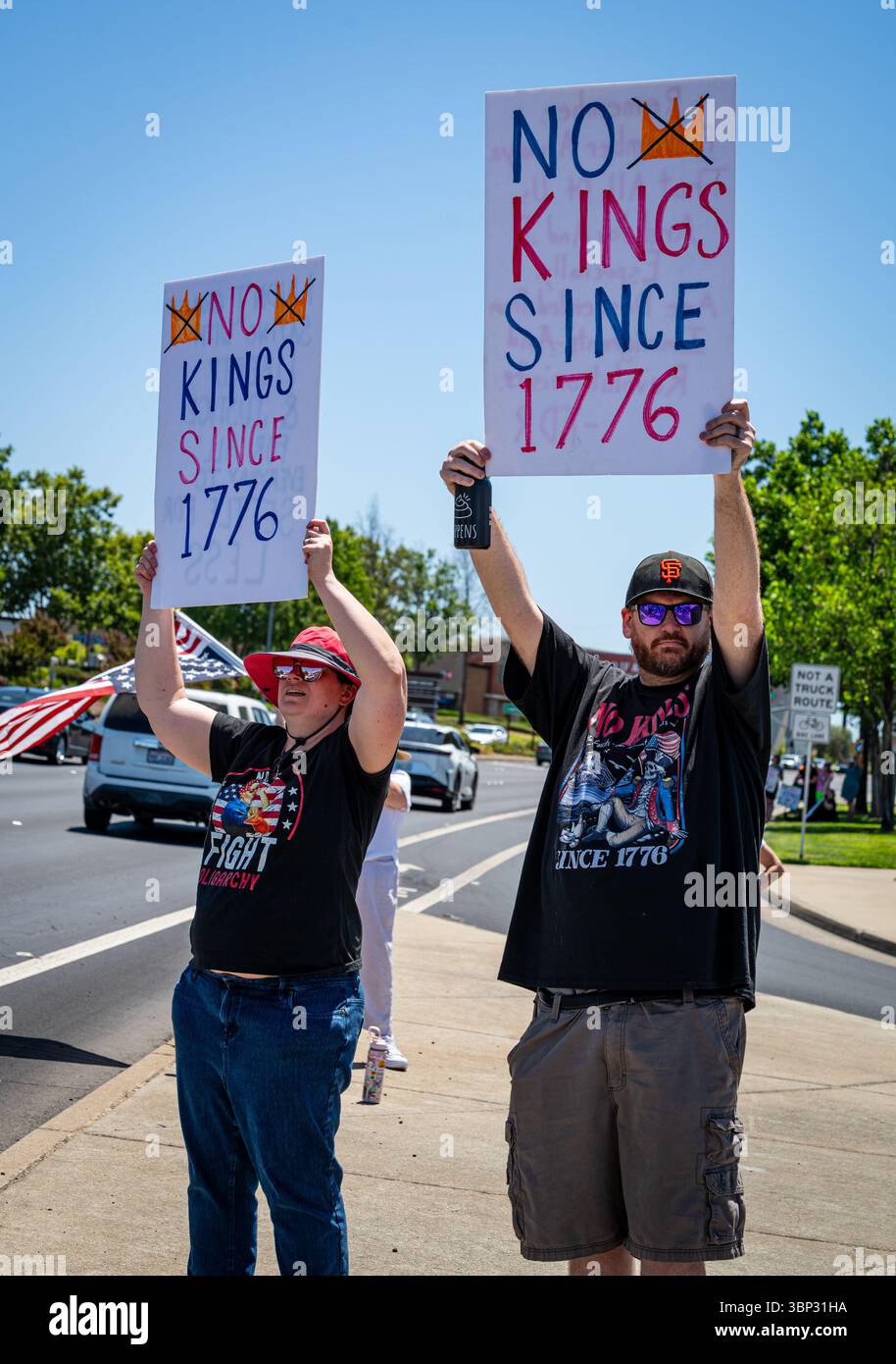 Two activists wave No Kings Since 1776 signs at a July 4 protest near ...