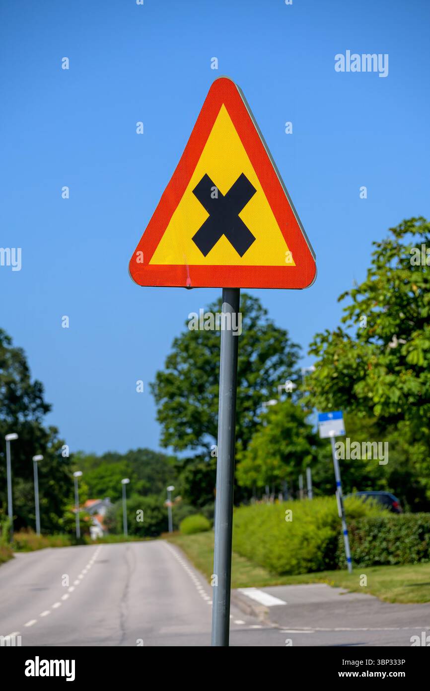 A triangular caution sign is prominently displayed in an urban ...