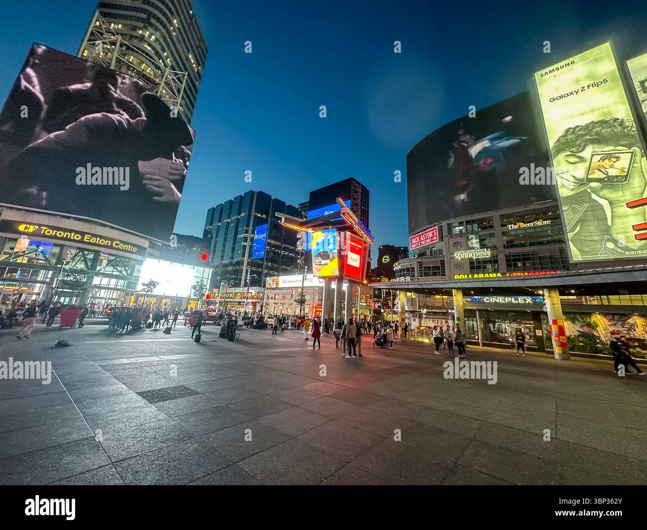 Toronto, Ontario - October 7, 2023: The vibrant nighttime scenery and people gathering at the corner of Yonge Street and Dundas in downtown Toronto Stock Photo