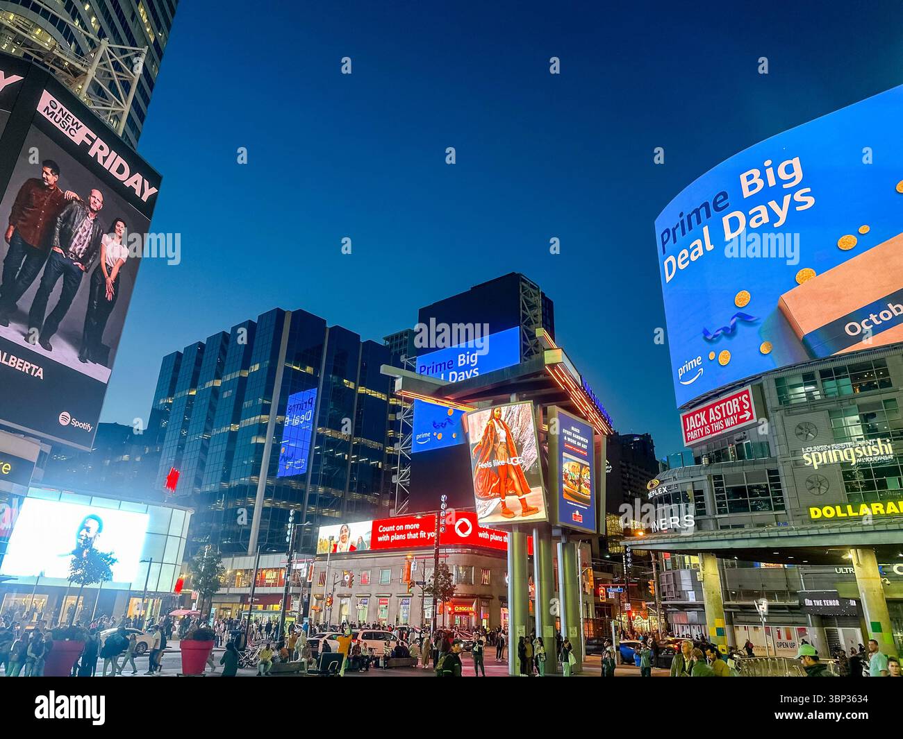 Toronto, Ontario - October 7, 2023: The vibrant nighttime scenery and people gathering at the corner of Yonge Street and Dundas in downtown Toronto Stock Photo