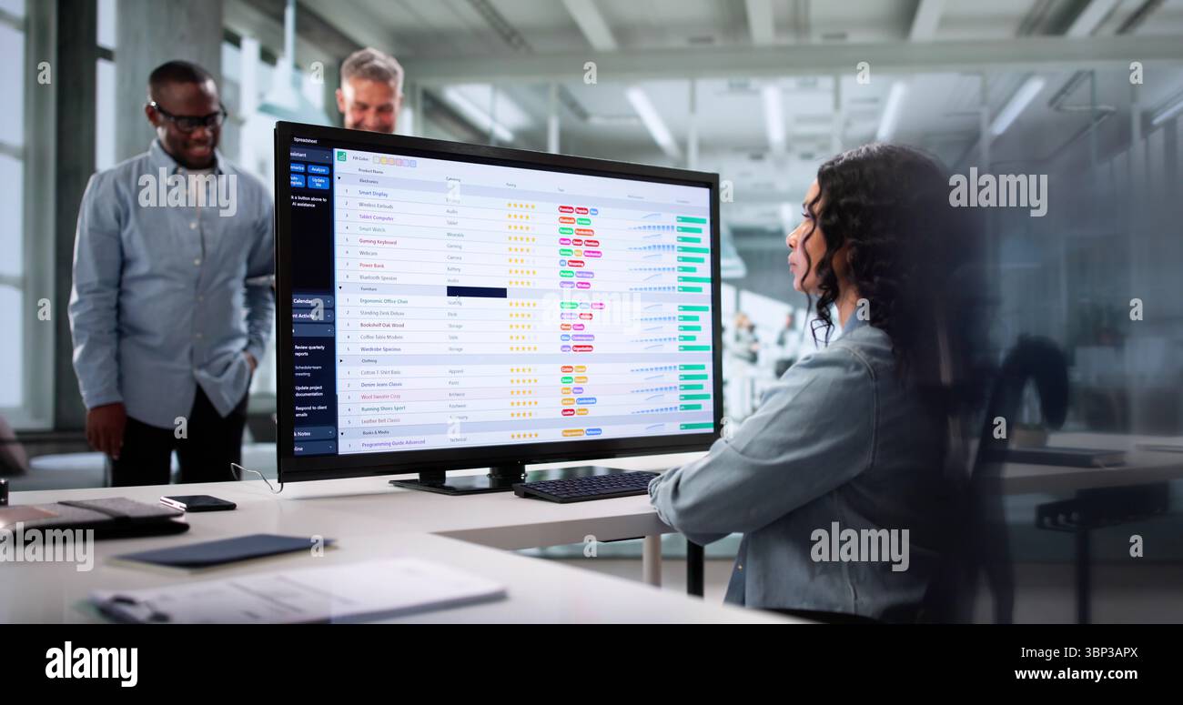 Diverse Team Of Professionals Using Spreadsheets To Analyze Data Together. Stock Photo