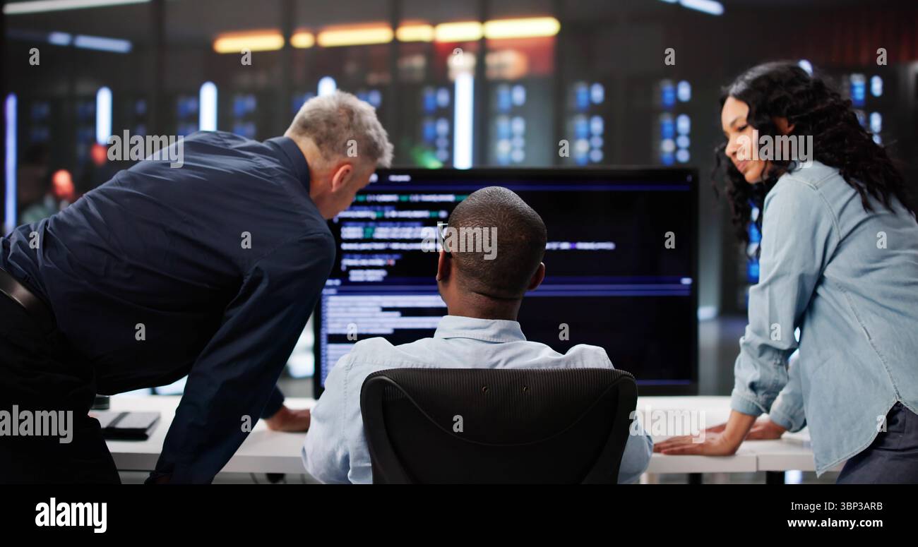 Agile Professionals Collaborate On Programming Efficiency In Diverse Team Setting. Stock Photo