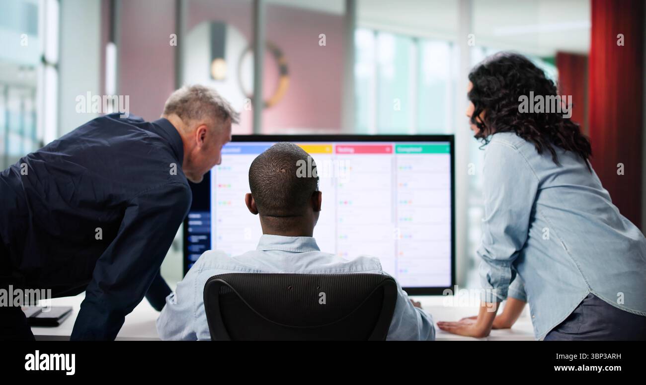 Diverse Development Team Collaborating On Kanban Board In Office Space. Stock Photo