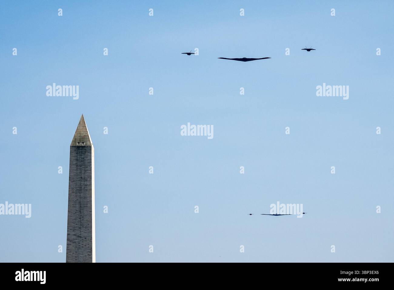 Five military aircraft fly in tight formation over the Washington Monument during Independence Day celebrations, with a stealth bomber leading the group accompanied by fighter jets and escort planes. Washington, D.C. | July 4, 2025. Image courtesy of the White House. Stock Photo