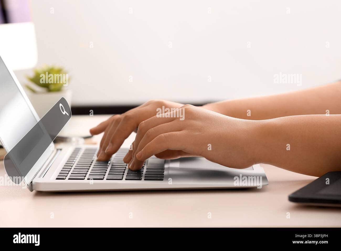 Woman with laptop using web search engine in office Stock Photo