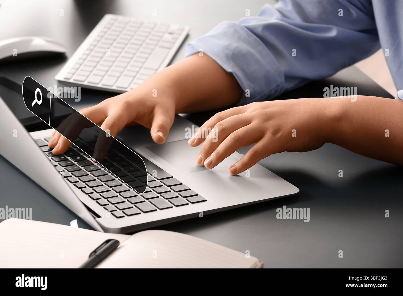 Woman with laptop using web search engine in office Stock Photo