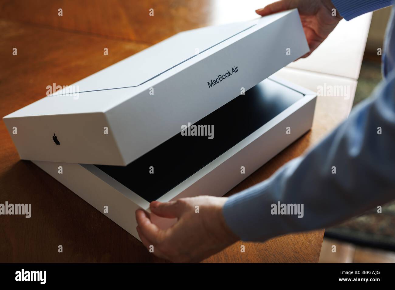 Zlin, Czech Republic - April 12, 2025: Apple laptop computer. Unboxing new MacBook Air 15 inch with M4 chip in midnight color Stock Photo