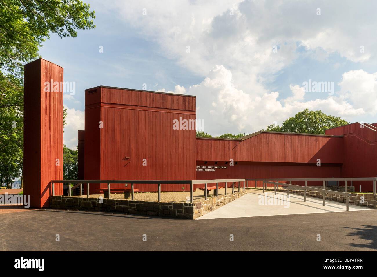 Fort Lee, NJ - US - Jul 2, 2025 The Fort Lee Historic Park Visitor Center features bold red modern architecture set against lush greenery, welcoming g Stock Photo