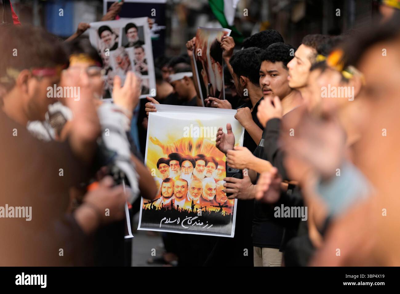 Shiite Muslims hold posters of Iranian religious leaders during a ...