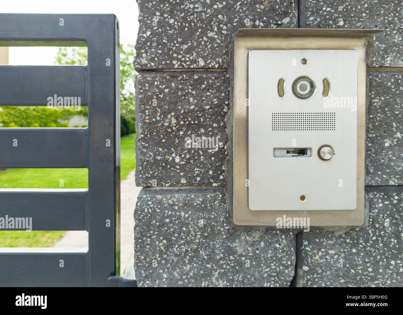 Stainless steel intercom on brick pillar Stock Photo