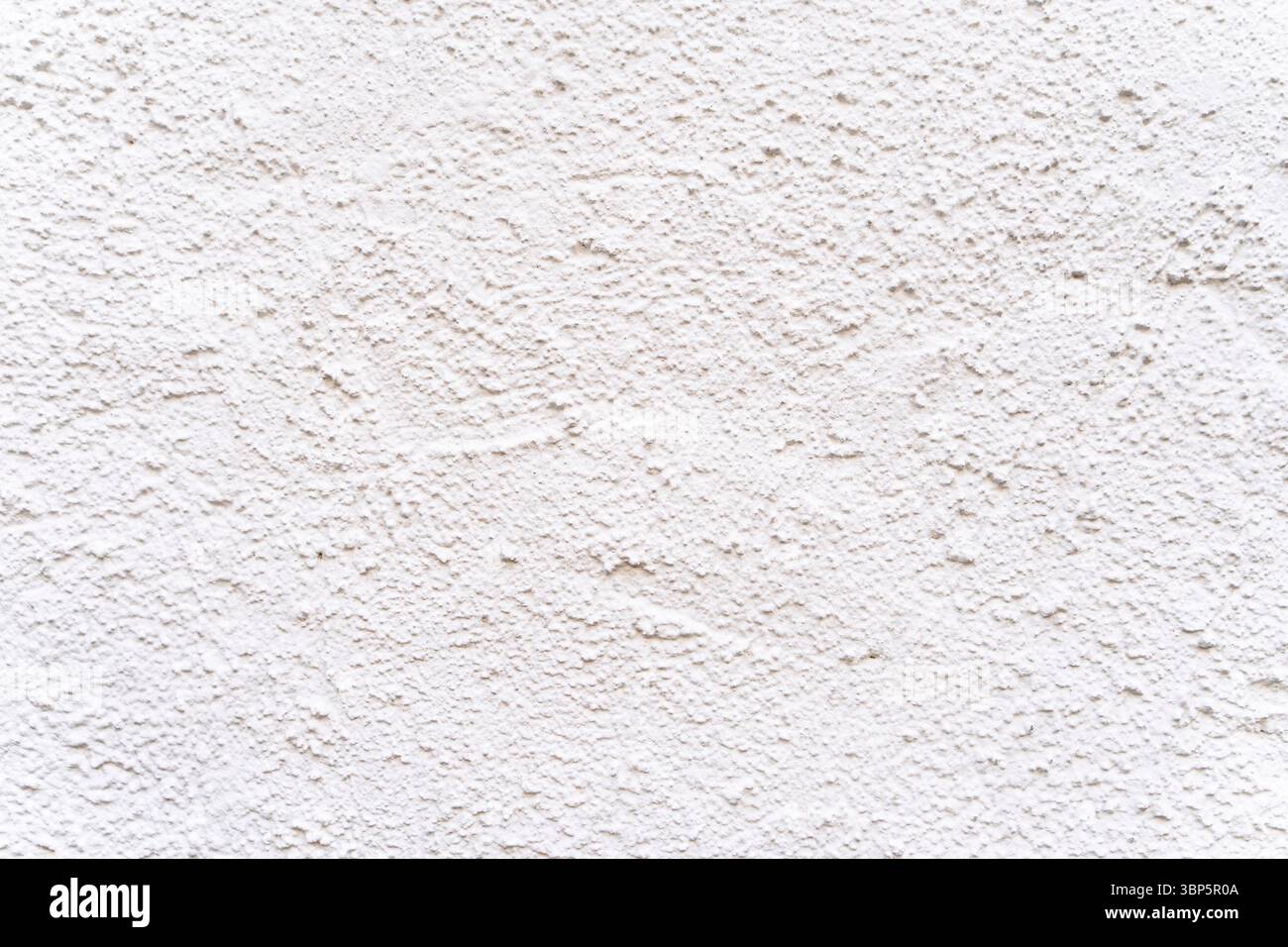 White textured plaster wall surface with rough grain pattern. Stock Photo