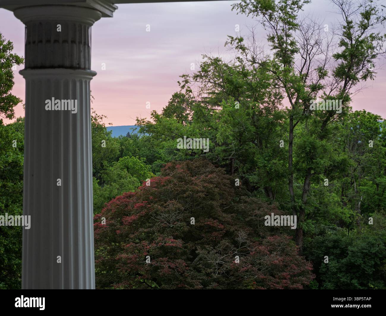 Twilight view of the tranquil landscape and colorful sky from the porch of Historic Rosemont, Berryville, Virginia. Stock Photo