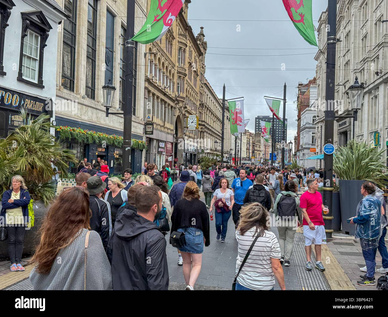 Oasis Fans and Buskers in Cardiff City Centre During Oasis Live ’25 Reunion Tour - Smartphone Captured Stock Image
