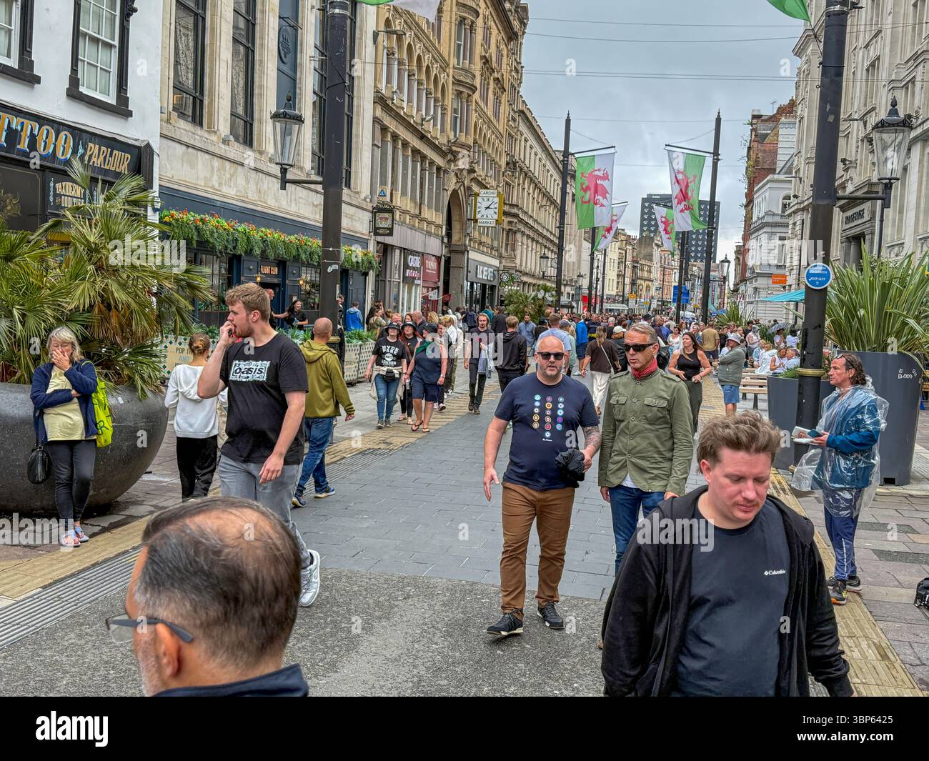 Oasis Fans and Buskers in Cardiff City Centre During Oasis Live ’25 Reunion Tour - Smartphone Captured Stock Image