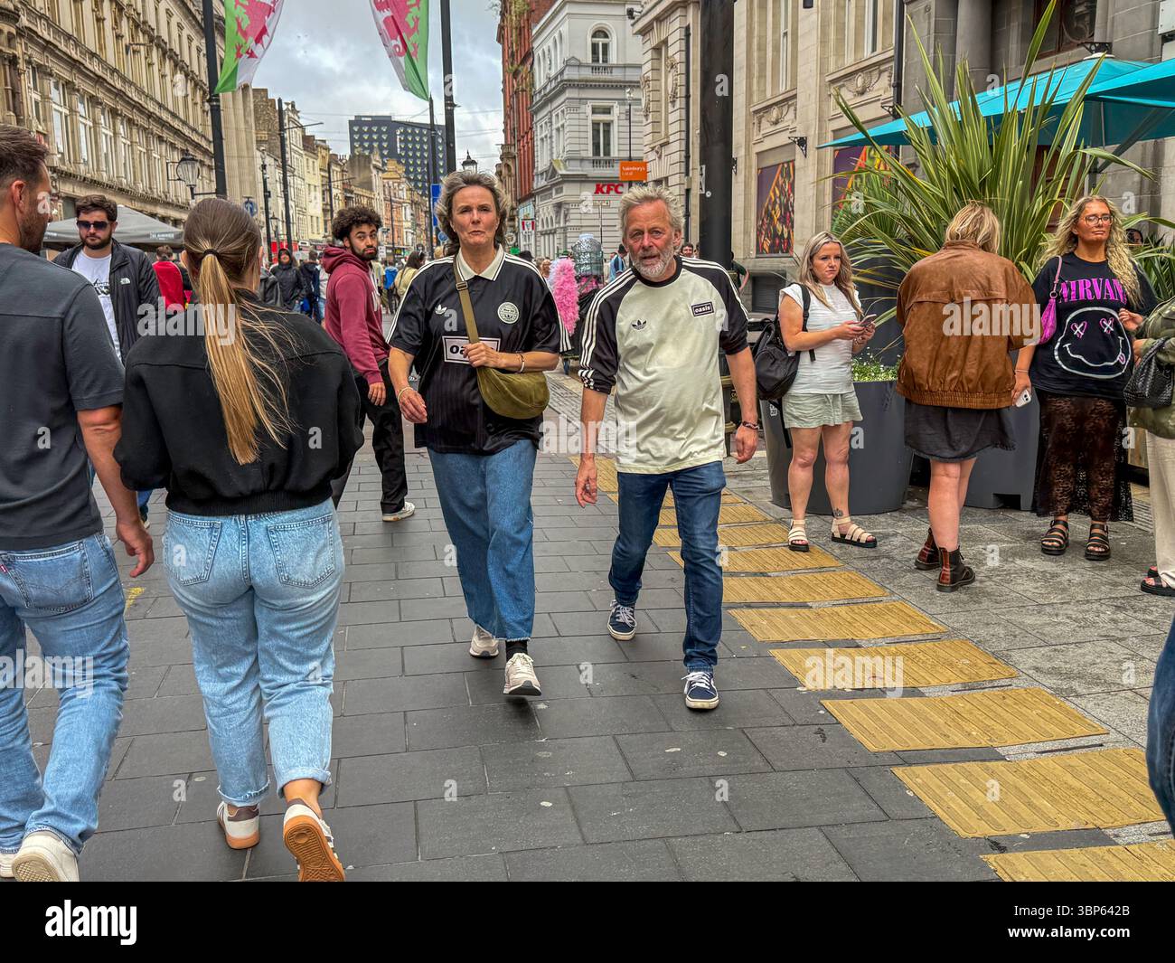 Oasis Fans and Buskers in Cardiff City Centre During Oasis Live ’25 Reunion Tour - Smartphone Captured Stock Image