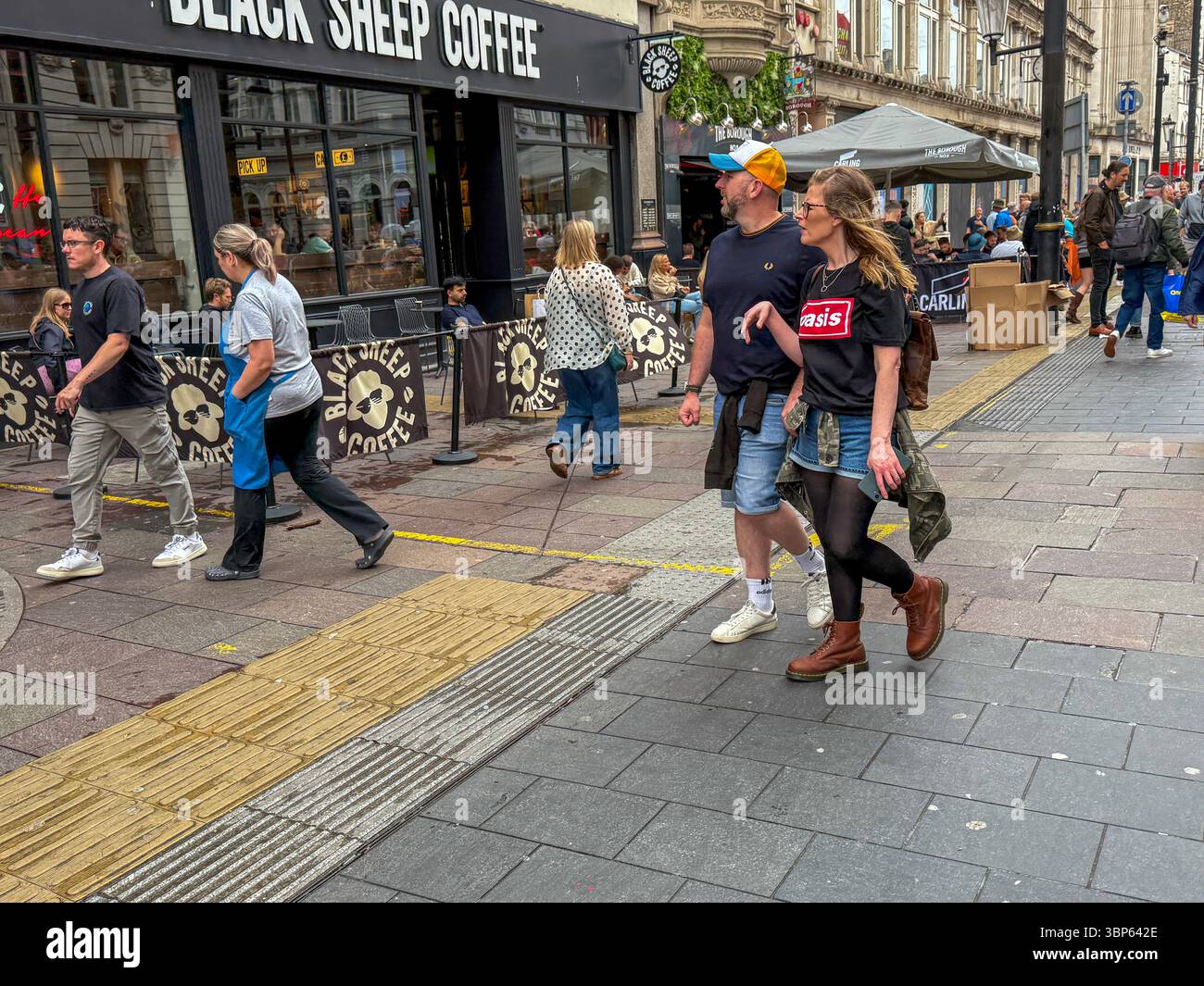 Oasis Fans and Buskers in Cardiff City Centre During Oasis Live ’25 Reunion Tour - Smartphone Captured Stock Image