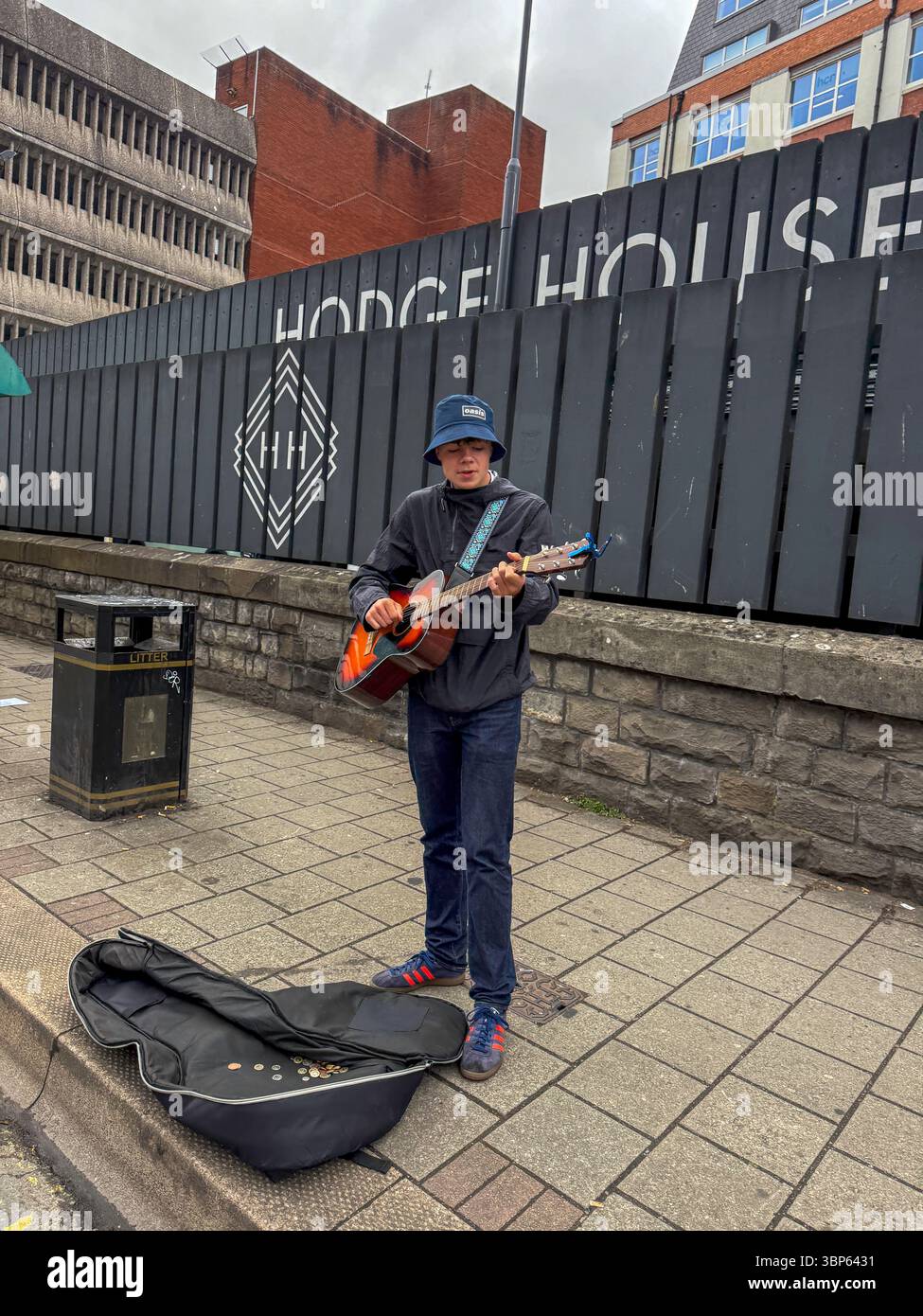 Oasis Fans and Buskers in Cardiff City Centre During Oasis Live ’25 Reunion Tour - Smartphone Captured Stock Image