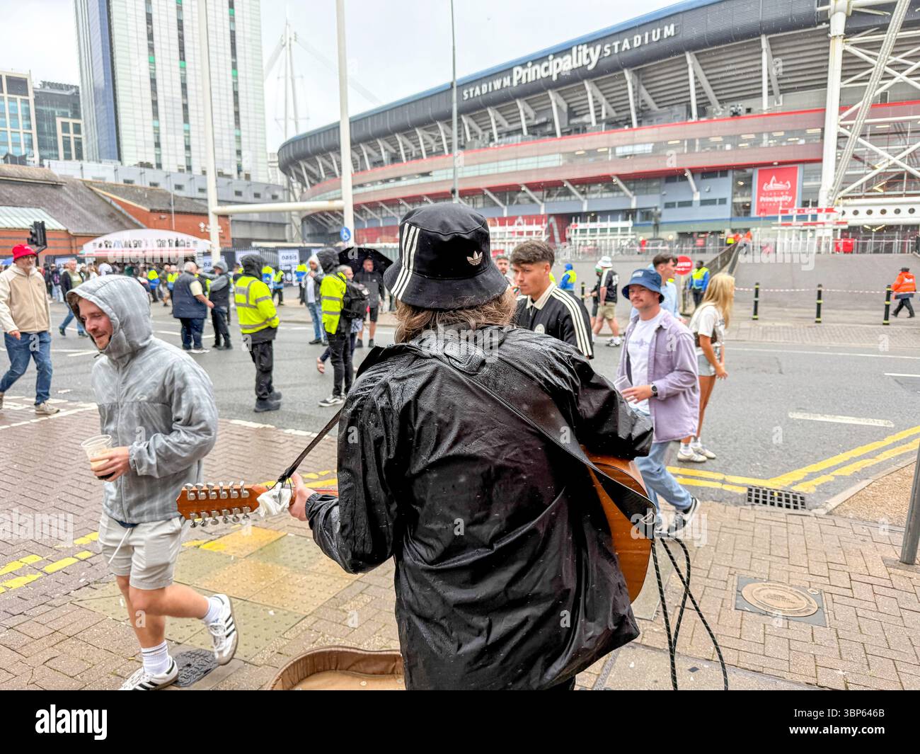 Oasis Fans and Buskers in Cardiff City Centre During Oasis Live ’25 Reunion Tour - Smartphone Captured Stock Image