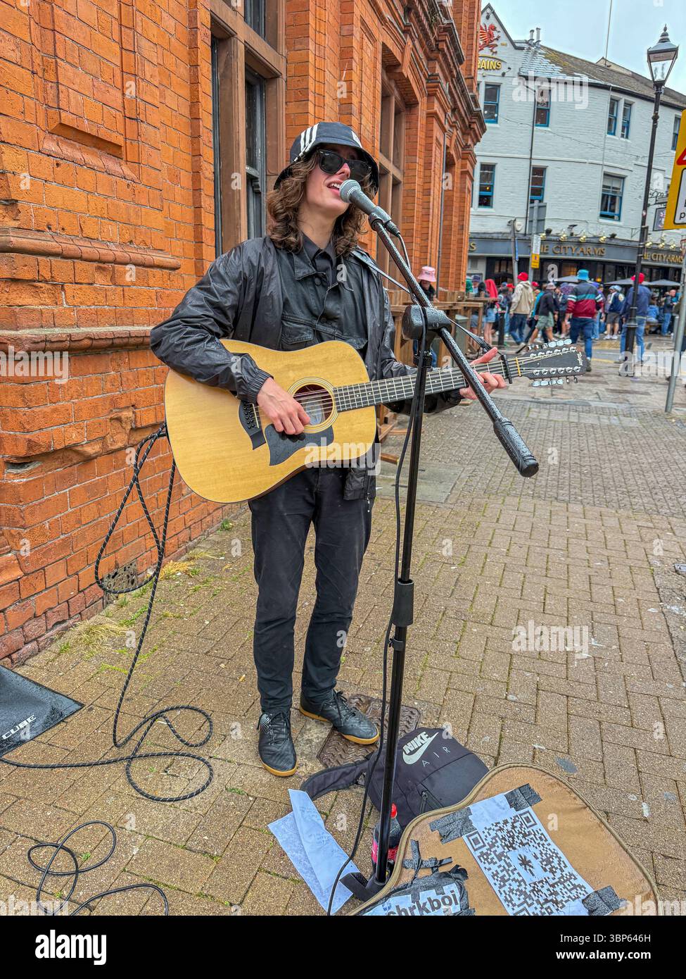 Oasis Fans and Buskers in Cardiff City Centre During Oasis Live ’25 Reunion Tour - Smartphone Captured Stock Image