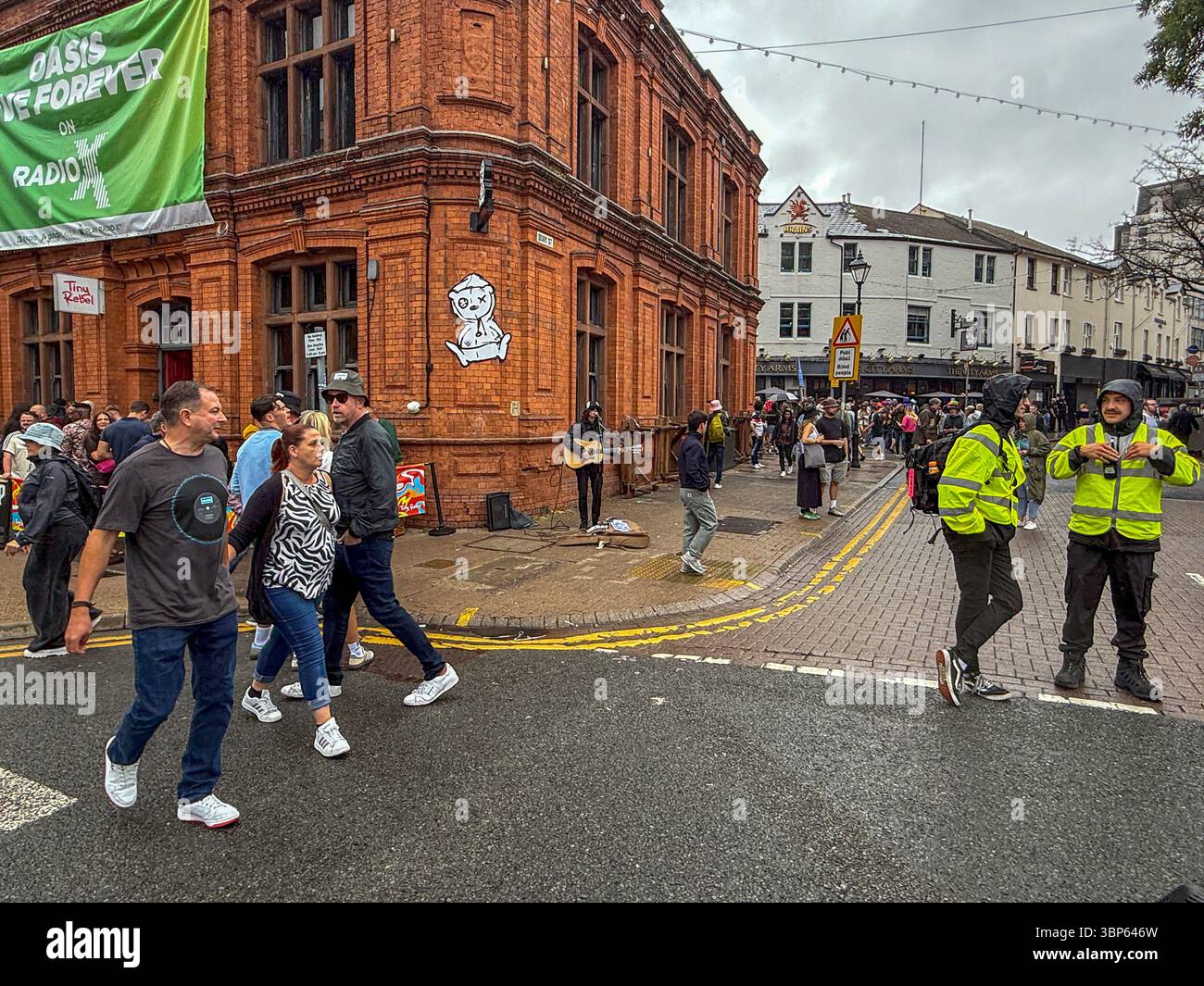 Oasis Fans and Buskers in Cardiff City Centre During Oasis Live ’25 Reunion Tour - Smartphone Captured Stock Image