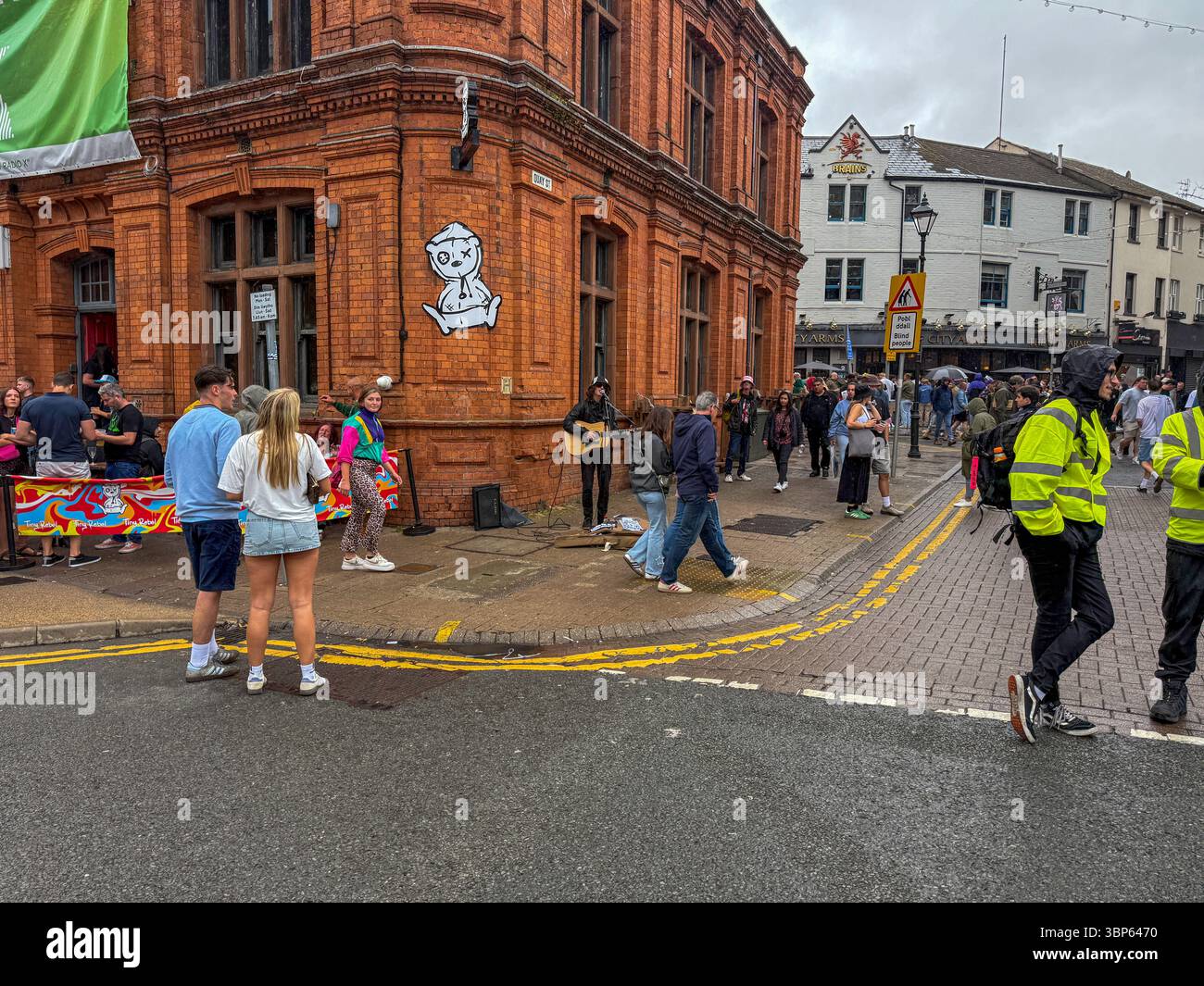 Oasis Fans and Buskers in Cardiff City Centre During Oasis Live ’25 Reunion Tour - Smartphone Captured Stock Image