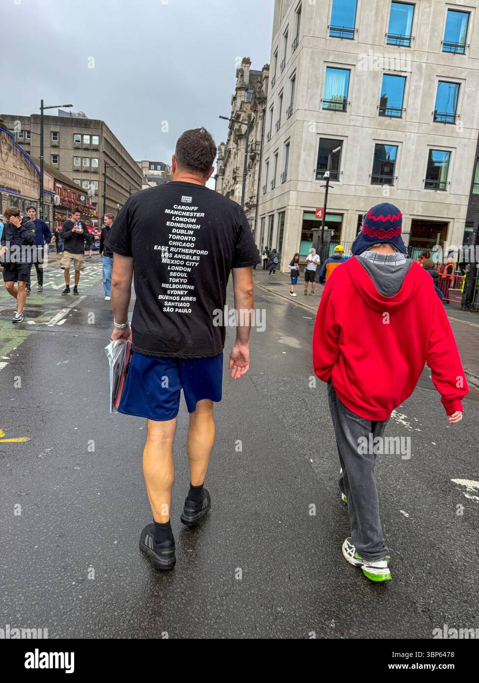 Oasis Fans and Buskers in Cardiff City Centre During Oasis Live ’25 Reunion Tour - Smartphone Captured Stock Image