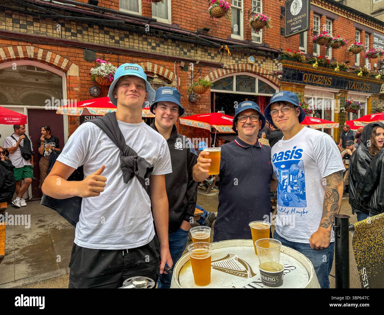 Oasis Fans and Buskers in Cardiff City Centre During Oasis Live ’25 Reunion Tour - Smartphone Captured Stock Image