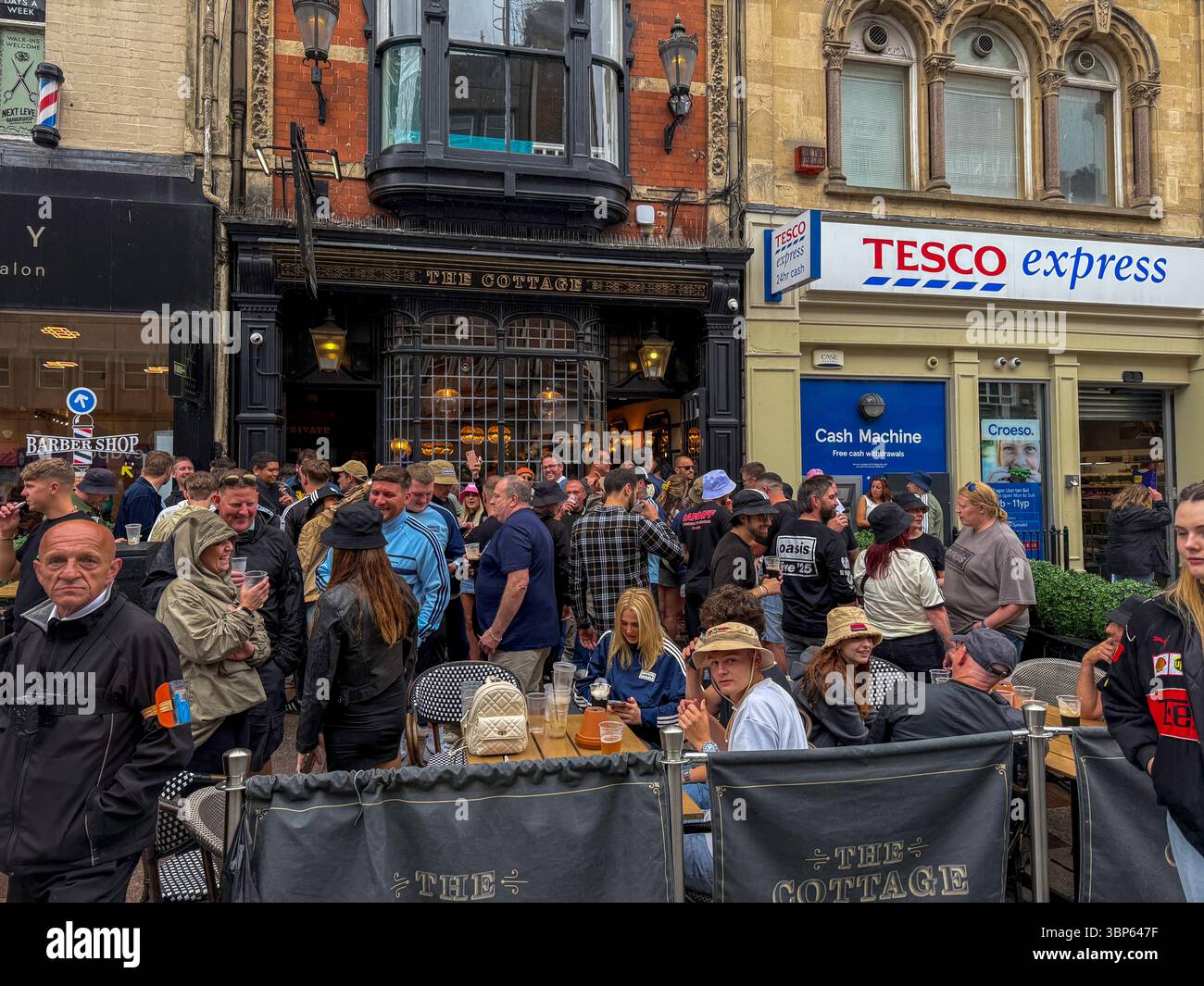 Oasis Fans and Buskers in Cardiff City Centre During Oasis Live ’25 Reunion Tour - Smartphone Captured Stock Image